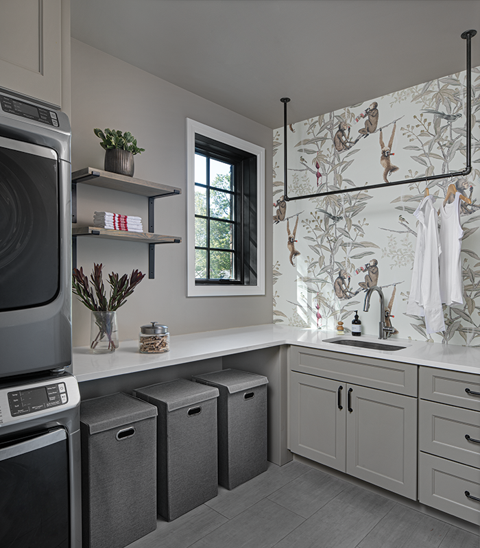 The laundry room’s pretty cabinetry, unique shelving, bright countertops, and Monocibec flooring from Virginia Tile make doing laundry a pleasure instead of a chore.